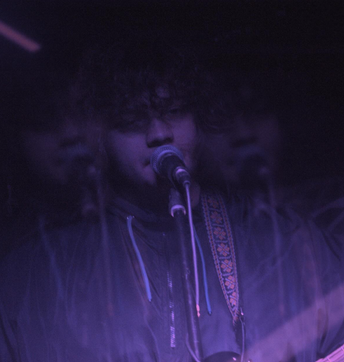 Me performing under purple stage lights