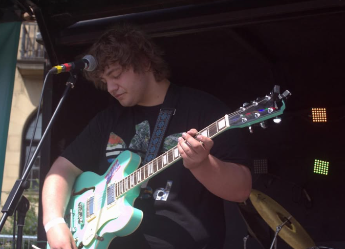 Me playing guitar on an outdoor stage